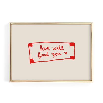 a framed piece of art with a handwritten message in red ink that reads "love will find you".