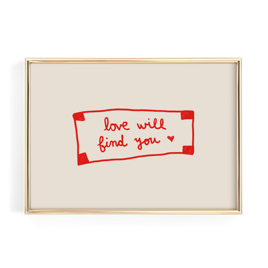 a framed piece of art with a handwritten message in red ink that reads "love will find you".