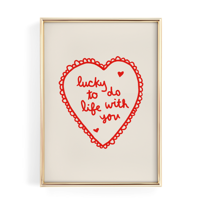 a heart-shaped graphic with the text "lucky to do life with you" written inside it.