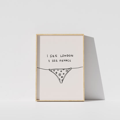 A framed print with the text "I see London I see France" and an illustration of a bikini bottom.