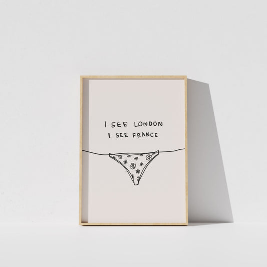 A framed print with the text "I see London I see France" and an illustration of a bikini bottom.