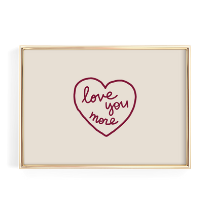 A framed image with a heart-shaped design containing the text "love you more" written in cursive.