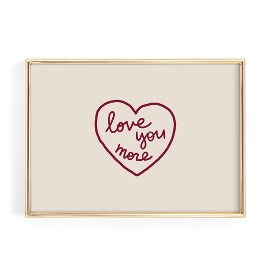 A framed image with a heart-shaped design containing the text "love you more" written in cursive.