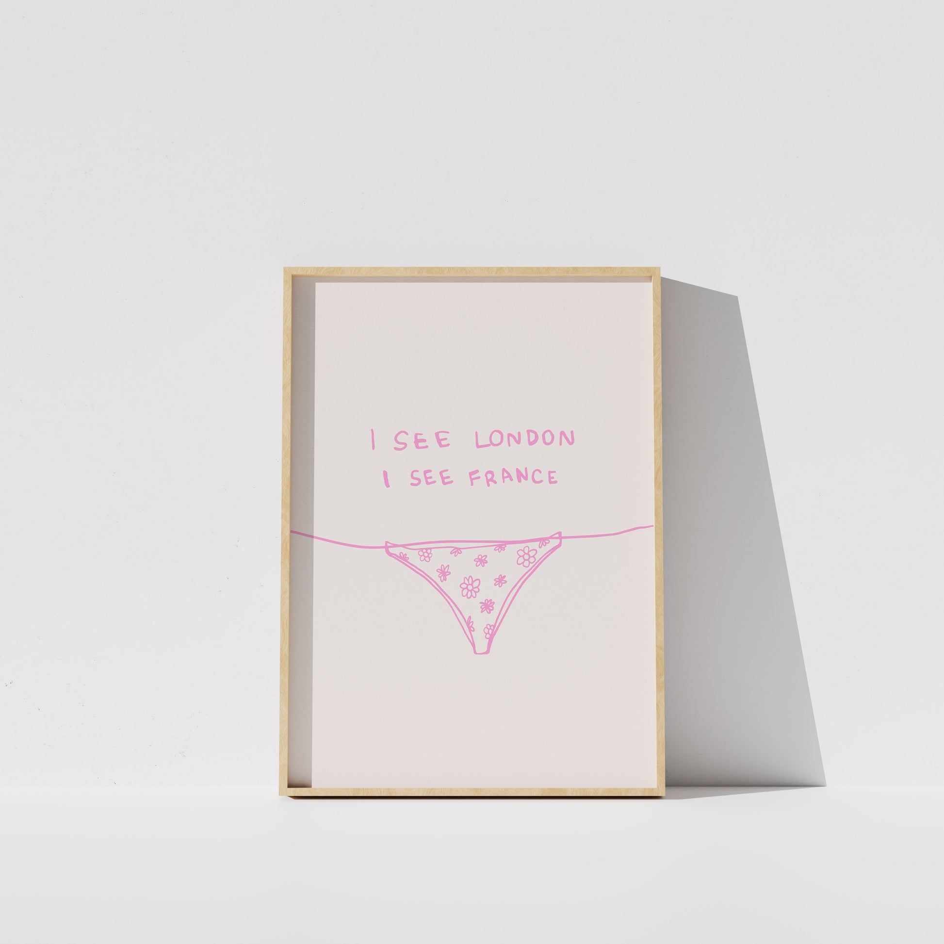 A framed poster with the text "I see London I see France" written on it, along with a simple illustration of a underwear or underwear-like object.