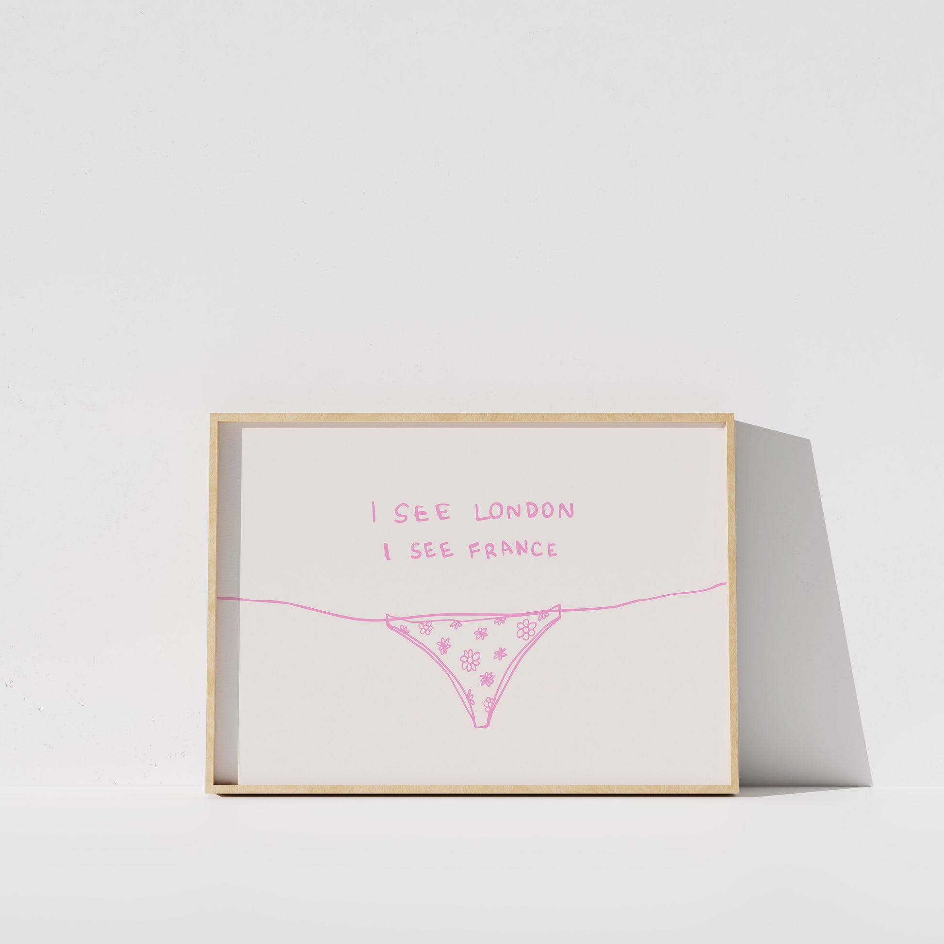 A framed print with the text "I see London I see France" written on it, along with a simple illustration of a underwear or underwear-like object.