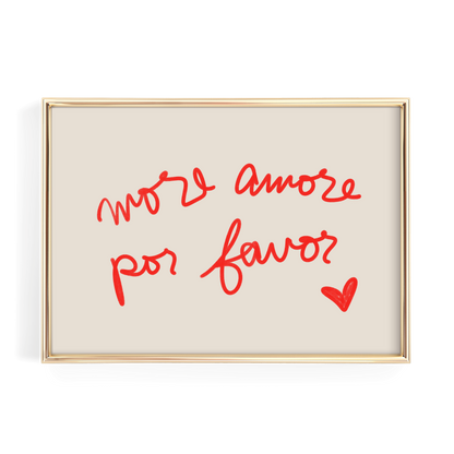 a framed piece of art with the handwritten text "More amore por favor?" and a small red heart symbol.