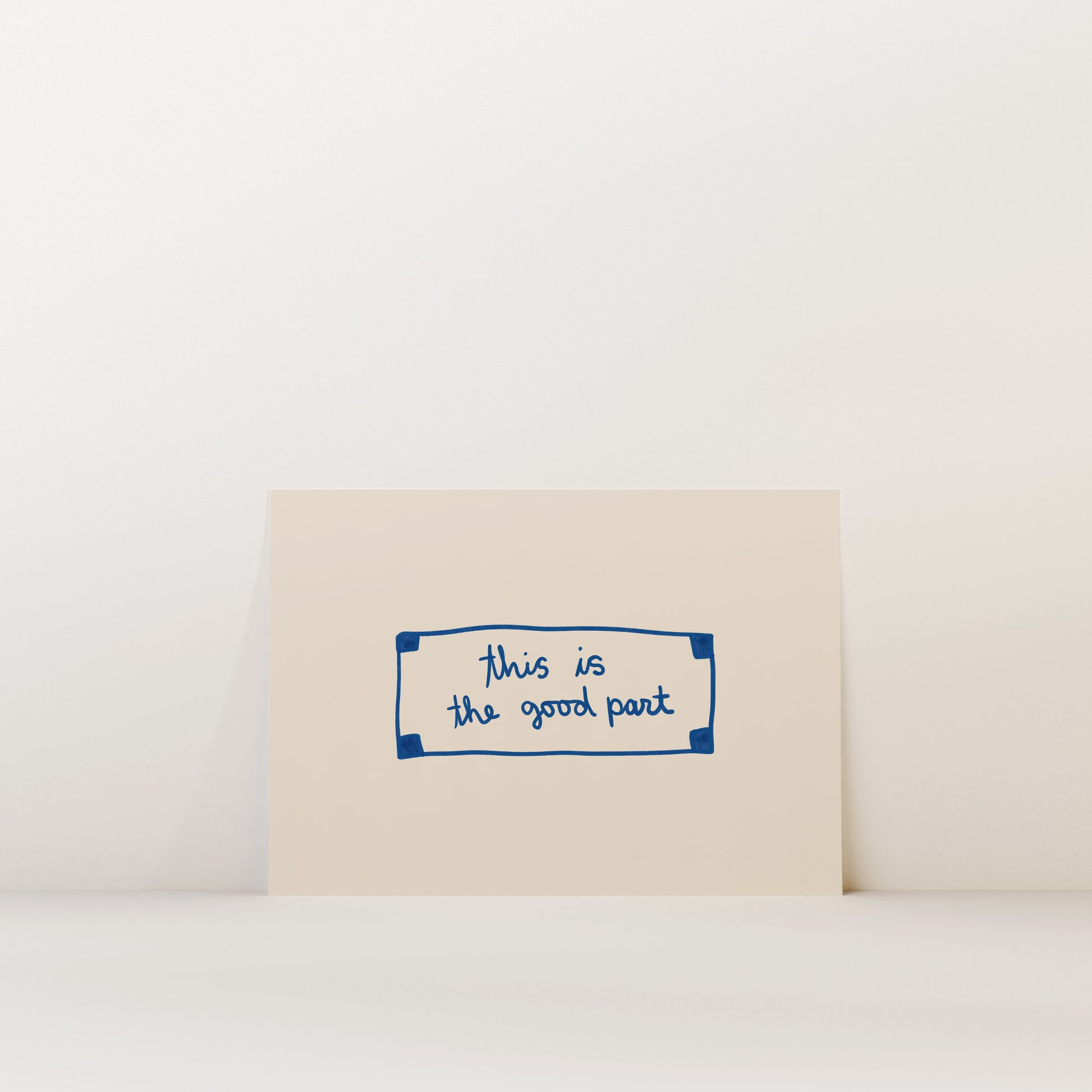 A beige card with a blue border and handwritten text that reads "This is the good part".