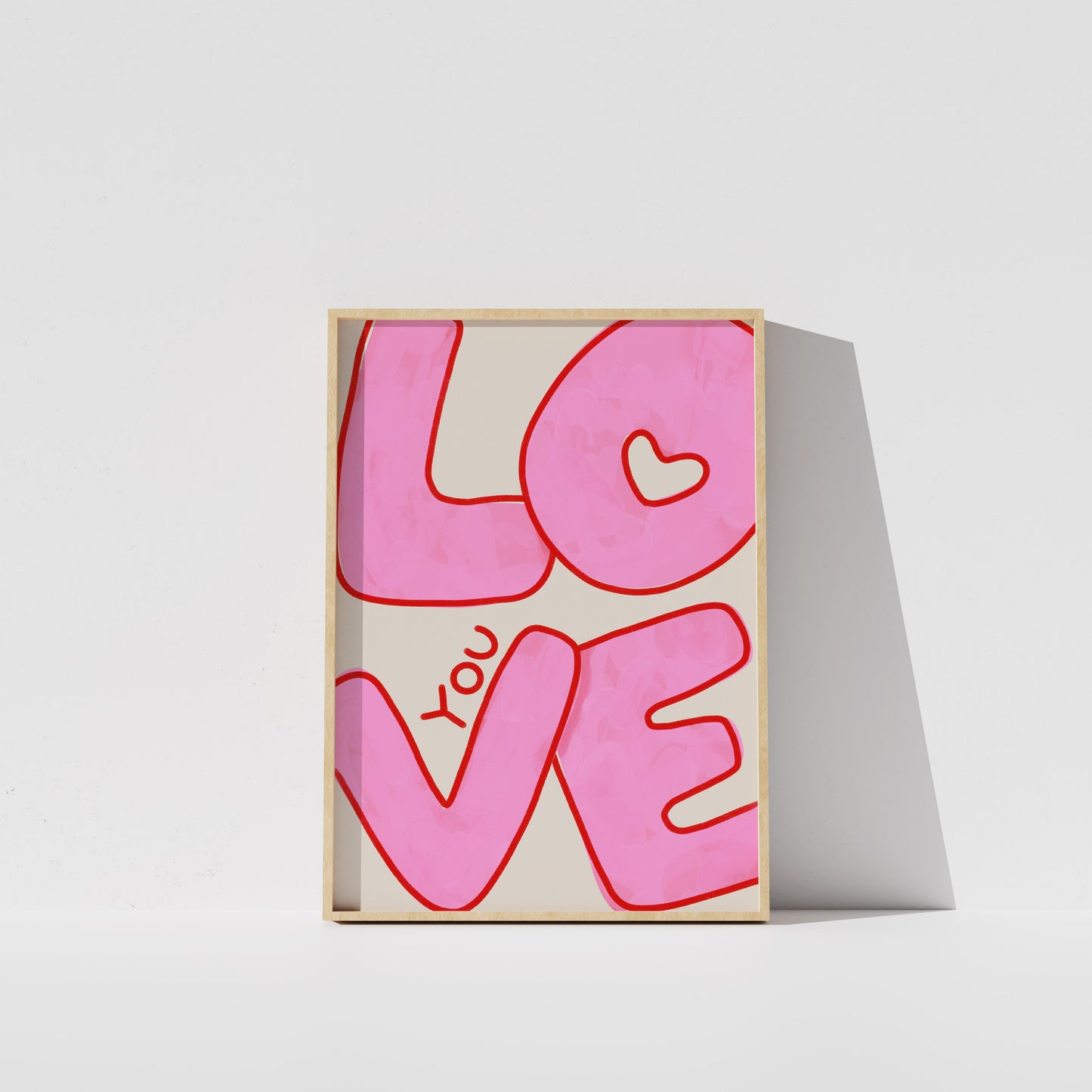 A framed poster with the word "LOVE" written in large pink letters.