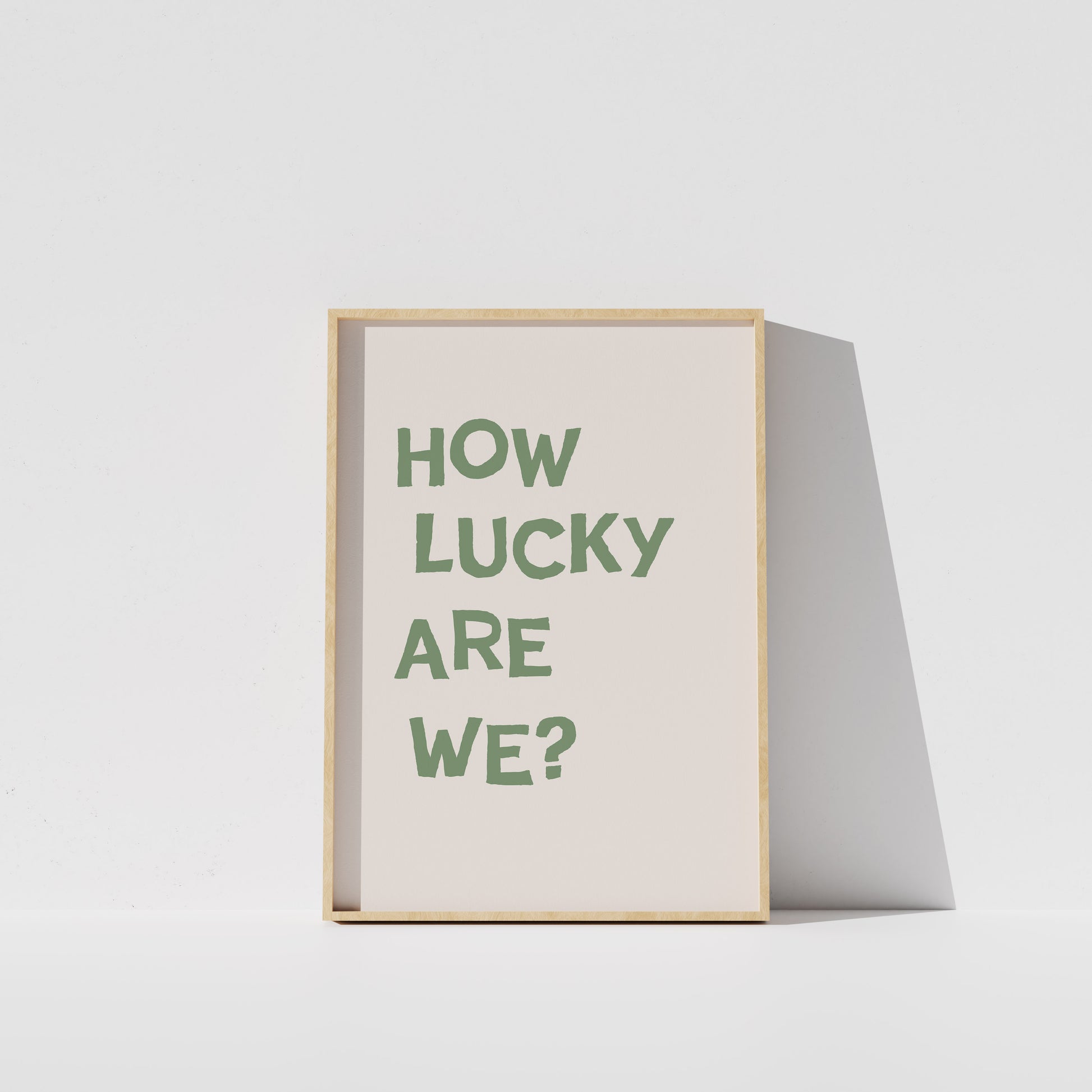 A framed poster with the text "HOW LUCKY ARE WE?" displayed on it.