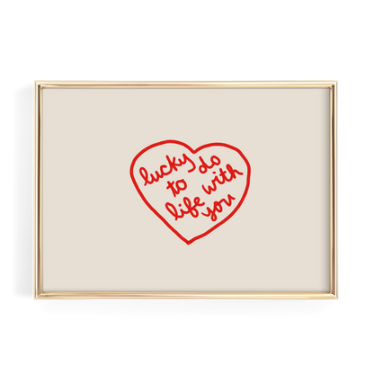a heart-shaped design with the text "lucky do with life you" written inside it.