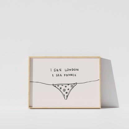 A framed print with a simple line drawing of a bikini bottom and the text "I see London I see France" written on it.