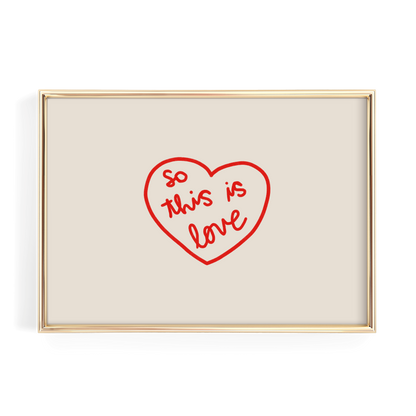 A framed image with a red heart-shaped design containing the text "So this is love" written in cursive.