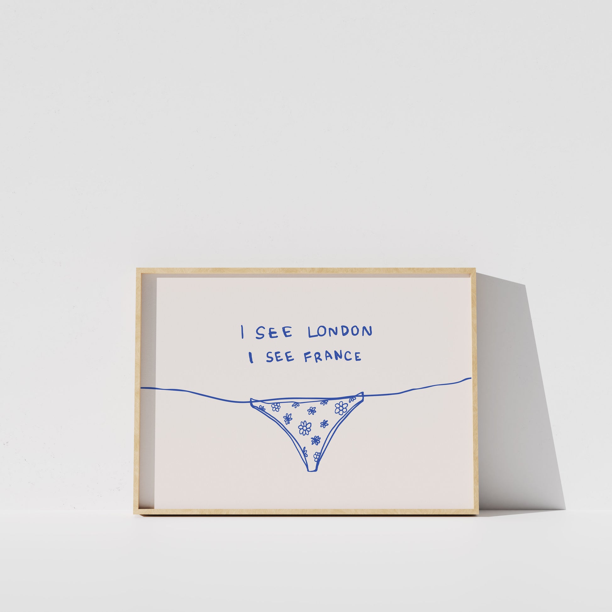 The image is a framed artwork with a simple drawing of a bikini bottom and the text "I SEE LONDON I SEE FRANCE" written on it.