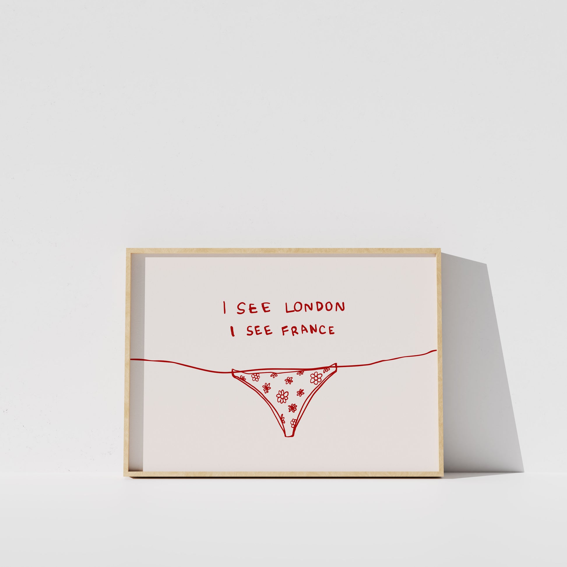 The image is a framed artwork with a simple design featuring a red patterned object, possibly a underwear or a bikini, and the text "I SEE LONDON I SEE FRANCE" written on it.