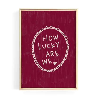 The image is a framed print with a red background and white text that reads "HOW LUCKY ARE WE".