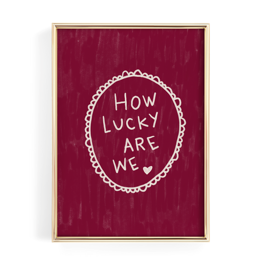 The image is a framed print with a red background and white text that reads "HOW LUCKY ARE WE".