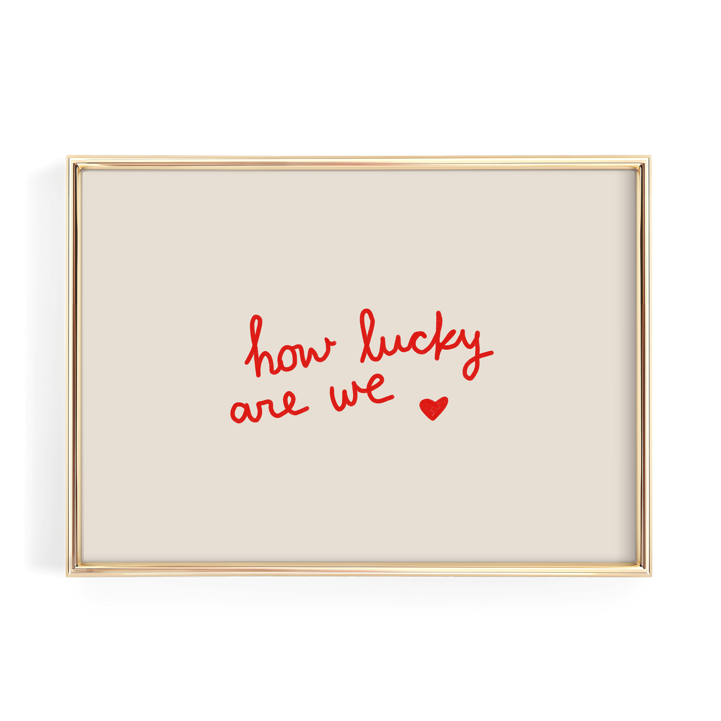 A gold-framed picture with a beige background and the text "how lucky are we" written in red cursive.